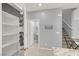A bright entryway with a coat rack, a pantry, and a staircase to the second floor at 965 Nevada State Dr # 36102, Henderson, NV 89002