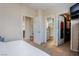 This bedroom boasts doors to an ensuite bathroom and a walk-in closet with customized storage at 10435 Meadow Village St, Las Vegas, NV 89183