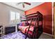 The bedroom features a bunk bed, window with shutters, ceiling fan, and neutral carpet at 10435 Meadow Village St, Las Vegas, NV 89183