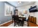 Cozy dining area featuring a dark wood table set, window with white shutters, and a TV at 10435 Meadow Village St, Las Vegas, NV 89183