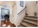 Interior hallway with a carpeted staircase and hardwood floors leading to the dining area at 10435 Meadow Village St, Las Vegas, NV 89183
