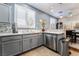 Well-lit kitchen featuring gray cabinets, stainless steel appliances, and granite countertops at 10435 Meadow Village St, Las Vegas, NV 89183