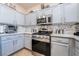 Modern kitchen with stainless steel appliances, stylish backsplash, and granite countertops at 10435 Meadow Village St, Las Vegas, NV 89183