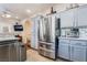 Open kitchen area with stainless steel appliances, gray cabinets, and access to the dining area at 10435 Meadow Village St, Las Vegas, NV 89183