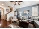 Inviting living room with hardwood floors, a comfortable sectional, and ample natural light at 10435 Meadow Village St, Las Vegas, NV 89183