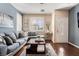 Inviting living room with hardwood floors, a comfortable sectional, and ample natural light at 10435 Meadow Village St, Las Vegas, NV 89183