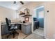Comfortable home office featuring built-in desk, shelving, and neutral décor at 10435 Meadow Village St, Las Vegas, NV 89183