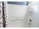 Clean shower-tub combo showcases white tile, a shower caddy, and sleek fixtures at 10435 Meadow Village St, Las Vegas, NV 89183