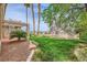 Well-manicured backyard featuring a pergola-covered patio, lush green lawn, and beautiful landscaping at 138 Wentworth Dr, Henderson, NV 89074