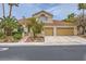 Charming two-story home featuring a tile roof, landscaped front yard, and an attached two-car garage at 138 Wentworth Dr, Henderson, NV 89074