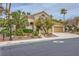 Attractive home with desert landscaping, a tile roof, and a two-car garage; neighborhood street view at 138 Wentworth Dr, Henderson, NV 89074