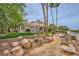 Beautiful home exterior featuring lush backyard, covered patios, and a tile roof at 138 Wentworth Dr, Henderson, NV 89074
