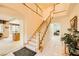 Grand foyer with staircase leading to upper level, arched doorways and tile flooring throughout at 138 Wentworth Dr, Henderson, NV 89074