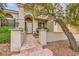 Charming front entrance with stone walkway, manicured landscaping, and decorative outdoor lanterns at 138 Wentworth Dr, Henderson, NV 89074