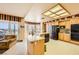 Bright, spacious kitchen with an island, stainless steel appliances, and a sliding door to patio at 138 Wentworth Dr, Henderson, NV 89074