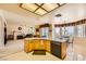 Open kitchen features an island, an adjacent sitting room, and a view of the landscaped backyard at 138 Wentworth Dr, Henderson, NV 89074