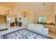 A comfortable living room with a staircase, chandelier, and view from the front door at 138 Wentworth Dr, Henderson, NV 89074
