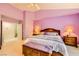 Stylish bedroom with vaulted ceilings, bedside tables, and a wooden chest at 138 Wentworth Dr, Henderson, NV 89074