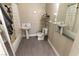 A full bathroom with a pedestal sink, toilet, shower, and a framed mirror at 1467 Hialeah Dr # D, Las Vegas, NV 89119