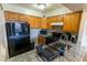 View of a well-organized kitchen featuring wood cabinets, granite countertop, and appliances at 1467 Hialeah Dr # D, Las Vegas, NV 89119