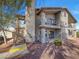 Multi-story building with balconies, stairs, and neutral-toned exterior at 1575 W Warm Springs Rd # 1111, Henderson, NV 89014