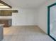 Open floor plan in living room and dining area with tile floors and sliding door access to the patio at 1575 W Warm Springs Rd # 1111, Henderson, NV 89014