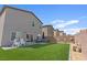 Spacious backyard featuring artificial grass, patio, and privacy fencing at 1876 Jamie Brook Pl, North Las Vegas, NV 89084