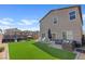 Large backyard featuring artificial grass, a patio area, and a trampoline at 1876 Jamie Brook Pl, North Las Vegas, NV 89084