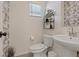 Bright bathroom featuring a stylish vanity, vessel sink and black and white wallpaper accent at 1876 Jamie Brook Pl, North Las Vegas, NV 89084