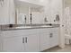 Bright bathroom featuring double sinks, granite countertops, and a large mirror at 1876 Jamie Brook Pl, North Las Vegas, NV 89084