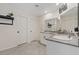 Bright bathroom featuring granite countertops, dual sinks, and modern fixtures at 1876 Jamie Brook Pl, North Las Vegas, NV 89084