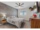 Stylish bedroom featuring modern decor, a ceiling fan, and a large window at 1876 Jamie Brook Pl, North Las Vegas, NV 89084