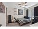 Comfortable bedroom featuring a ceiling fan, modern decor, and ample sunlight at 1876 Jamie Brook Pl, North Las Vegas, NV 89084