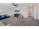 Large bonus room features neutral tones, a ceiling fan, and comfortable furnishings at 1876 Jamie Brook Pl, North Las Vegas, NV 89084