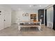 Open-concept dining area with a rustic wood table, bench seating, and a decorative cabinet at 1876 Jamie Brook Pl, North Las Vegas, NV 89084