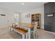 Bright dining area features a rustic wood table with bench seating and decorative cabinet at 1876 Jamie Brook Pl, North Las Vegas, NV 89084