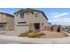 Beautiful two-story home with a two-car garage, low maintenance desert landscaping, and a brick privacy wall at 1876 Jamie Brook Pl, North Las Vegas, NV 89084