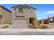 Charming two-story home with a well-manicured front yard and an attached two-car garage in a suburban neighborhood at 1876 Jamie Brook Pl, North Las Vegas, NV 89084