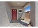 Inviting front porch with a covered entrance, brick flooring, a decorative bench, and a 'Welcome' mat at 1876 Jamie Brook Pl, North Las Vegas, NV 89084