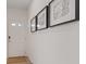 Bright hallway featuring modern artwork, a white front door with glass panes, and neutral flooring at 1876 Jamie Brook Pl, North Las Vegas, NV 89084