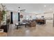 Open-concept living space featuring tile floors, a ceiling fan, and a seamless transition to the modern kitchen at 1876 Jamie Brook Pl, North Las Vegas, NV 89084