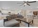Spacious living area with tiled flooring, an open layout, and easy access to the kitchen and dining spaces at 1876 Jamie Brook Pl, North Las Vegas, NV 89084