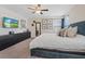 Main bedroom offers a serene retreat with carpet, ceiling fan, large windows, and ample closet space at 1876 Jamie Brook Pl, North Las Vegas, NV 89084