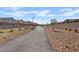 Scenic walking path lined with gravel landscaping, streetlights, and young trees, perfect for a leisurely stroll at 1876 Jamie Brook Pl, North Las Vegas, NV 89084