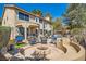 Inviting backyard featuring a fire pit, outdoor kitchen, and covered patio with comfortable seating, perfect for entertaining at 20 High Sierra Dr, Henderson, NV 89074