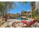 Outdoor pool and spa, rock waterfall, and patio of this beautiful and spacious home at 20 High Sierra Dr, Henderson, NV 89074