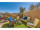 A charming backyard with a cozy seating area, vibrant artificial turf, and serene surroundings under a clear blue sky at 20 High Sierra Dr, Henderson, NV 89074