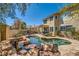 This resort style backyard offers a pool, spa, waterfalls and outdoor seating areas at 20 High Sierra Dr, Henderson, NV 89074