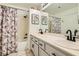 Well-lit bathroom featuring a shower with tub and a dual sink vanity with a large mirror at 20 High Sierra Dr, Henderson, NV 89074