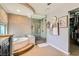 Relaxing bathroom with a soaking tub, frameless glass shower, and easy access to the walk-in closet at 20 High Sierra Dr, Henderson, NV 89074